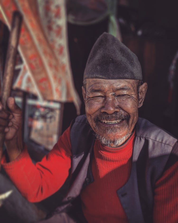 Cheerful Senior Asian Man Raising Fist