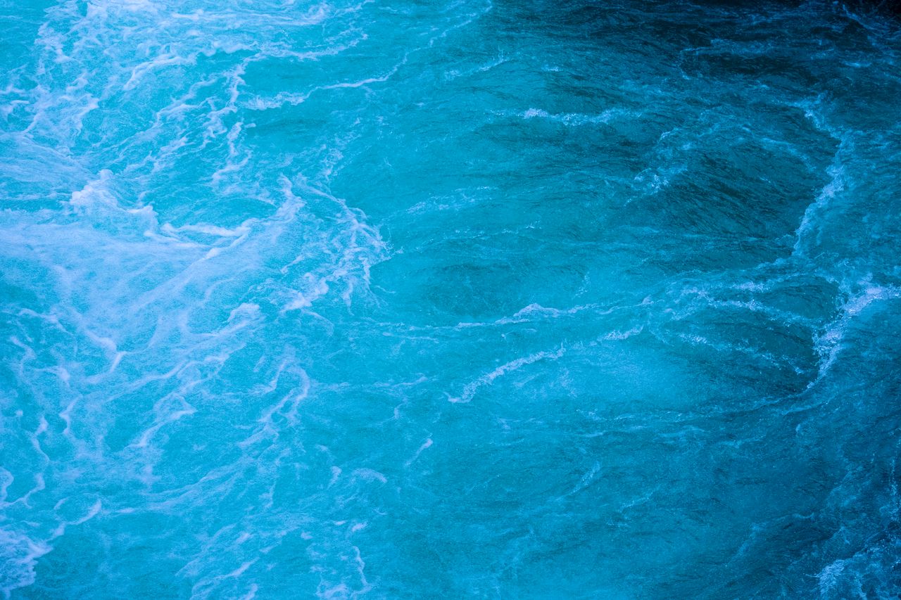 a dynamic capture of turquoise ocean waves with a rich texture perfect