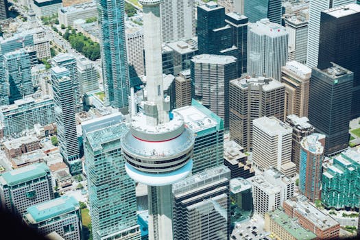 Stunning aerial view of CN Tower surrounded by skyscrapers in downtown Toronto.
