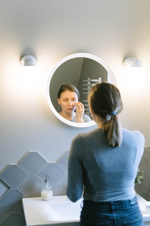 Woman in Front of a Round Mirror