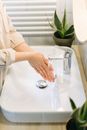 Person in White Long Sleeve Shirt Holding Clear Glass Pitcher