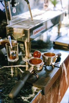 Close-up of espresso portafilter and machine on a cafe counter, capturing a modern coffee-making scene.