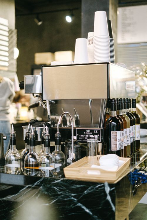 Free Close-up of a modern espresso machine with syrups at a coffee shop counter. Stock Photo