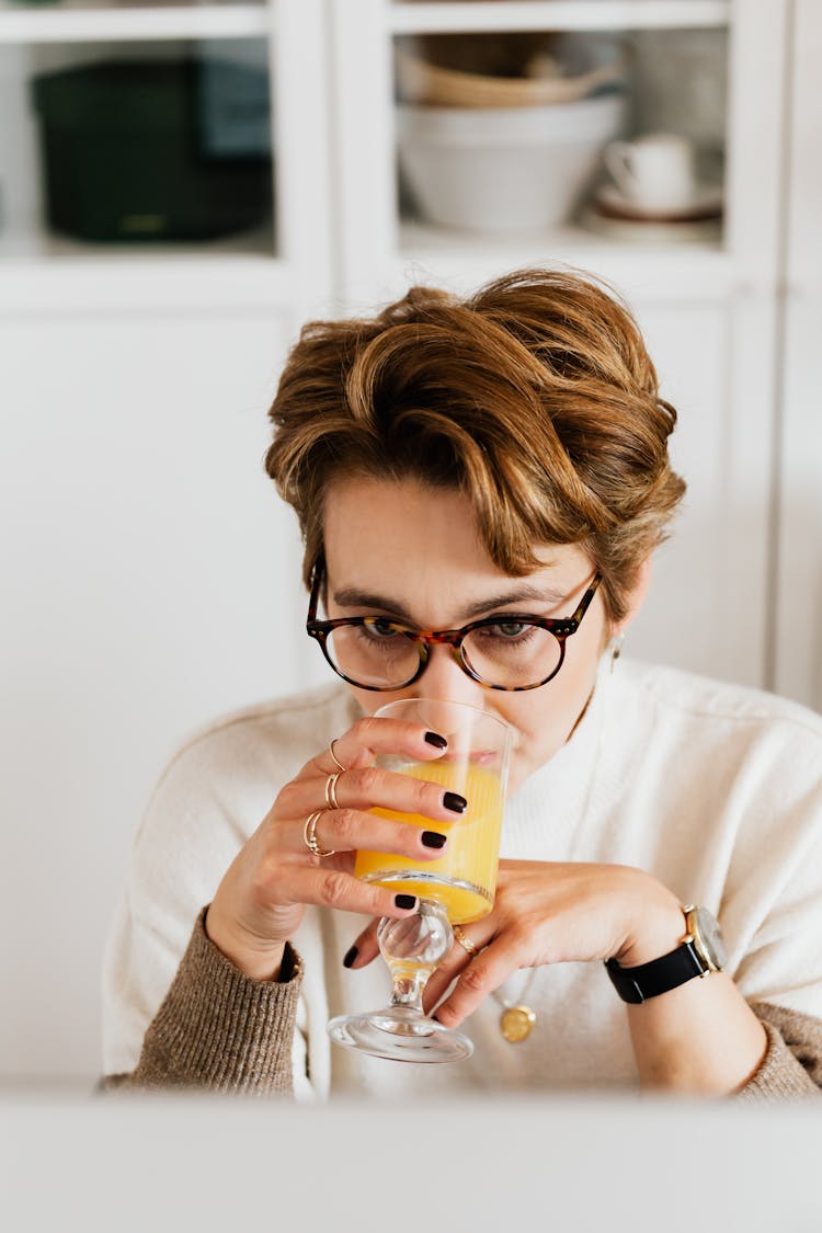 Adult Lady Drinking Fresh Juice While Working In Office