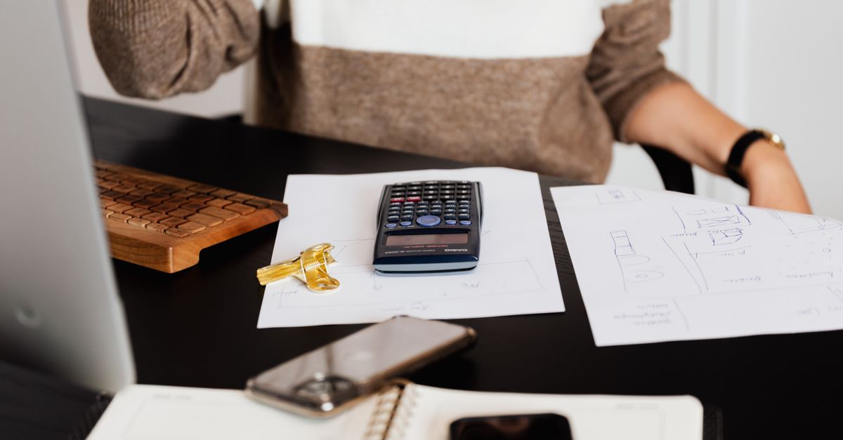 Hispanic woman on smartphone comparing insurance options with car keys on table in Texas