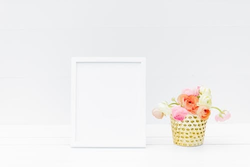 Flowers Beside an Empty Picture Frame