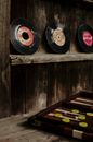 Old vinyl records on weathered shelf with backgammon