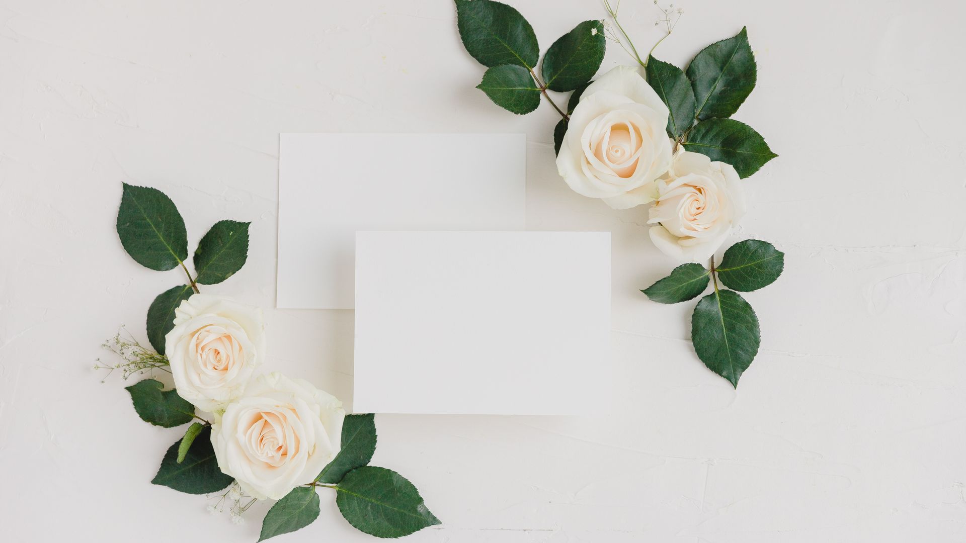 Wedding Cards: Your Guide to the Perfect Invitation 3 Top view of a blank card with white roses on a white background, ideal for invitations or announcements — wedding cards