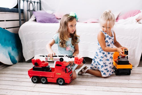 Young Girls Playing with Toy Cars