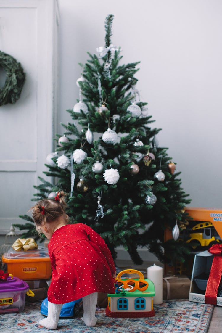 Baby Girl Looking At Christmas Presents