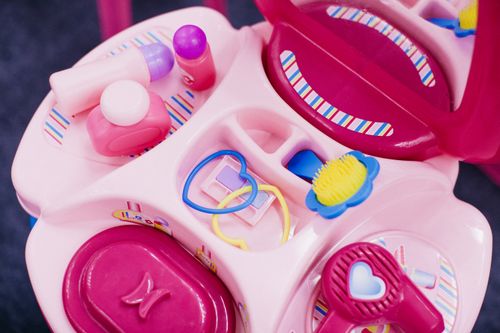 Free Bright children's vanity table with toy cosmetics and accessories. Perfect for imaginative play. Stock Photo