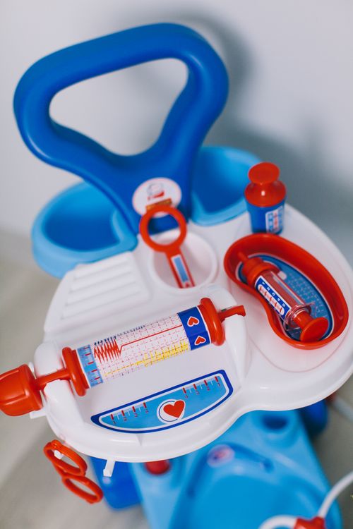 Free Plastic toy medical kit featuring a syringe and other tools for pretend play by children. Stock Photo