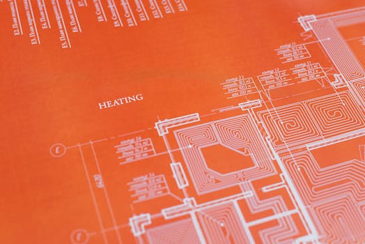 Close-up of an orange architectural heating blueprint showing intricate design details.