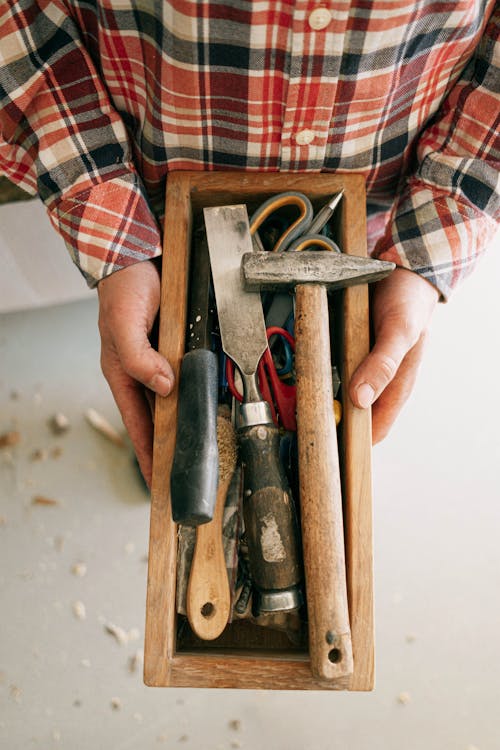 Person Holding Brown Wooden Handle