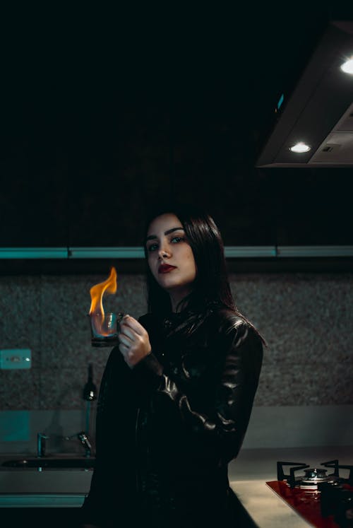 Free Woman in Black Leather Jacket Holding Orange Fire Stock Photo