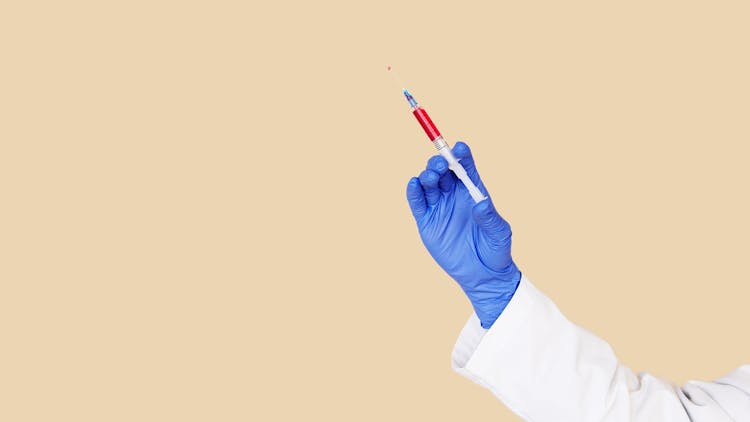 Crop Doctor In White Uniform And Blue Gloves With Syringe