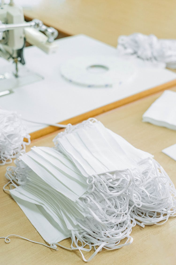 A Pile Of White Face Masks