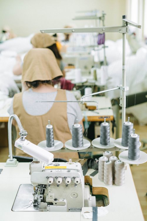 Spools of Thread Near a Sewing Machine · Free Stock Photo