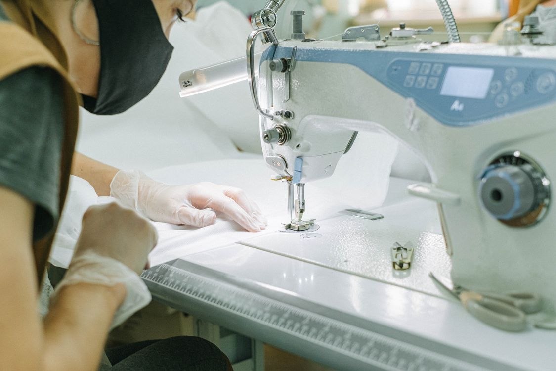 Person Using Stitching Machine Person Using a Sewing Machine · Free Stock Photo