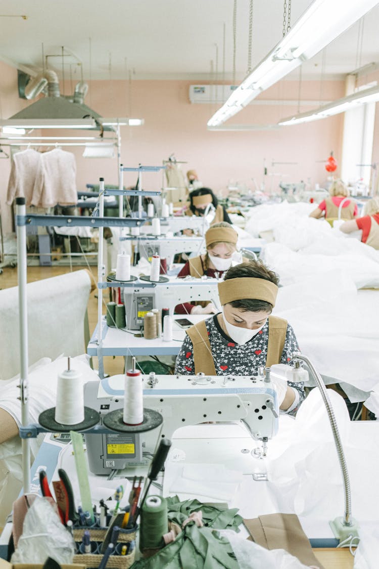 Women Wearing Face Masks Working In A Sewing Factory 