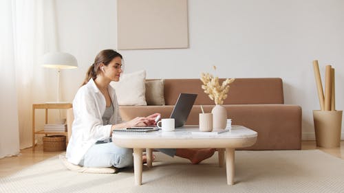 Free Content woman using laptop on floor Stock Photo