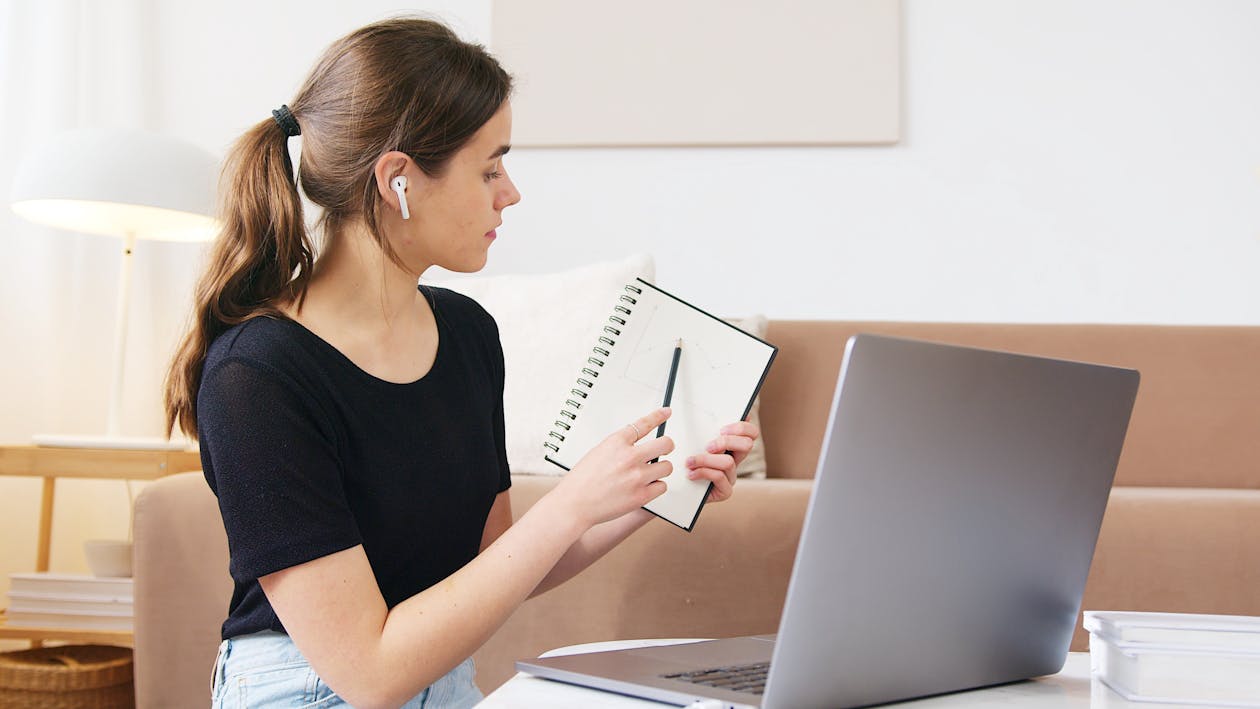 Focused woman using laptop while attending online webinar