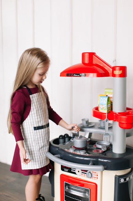 A Girl Playing on a Miniature Kitchen