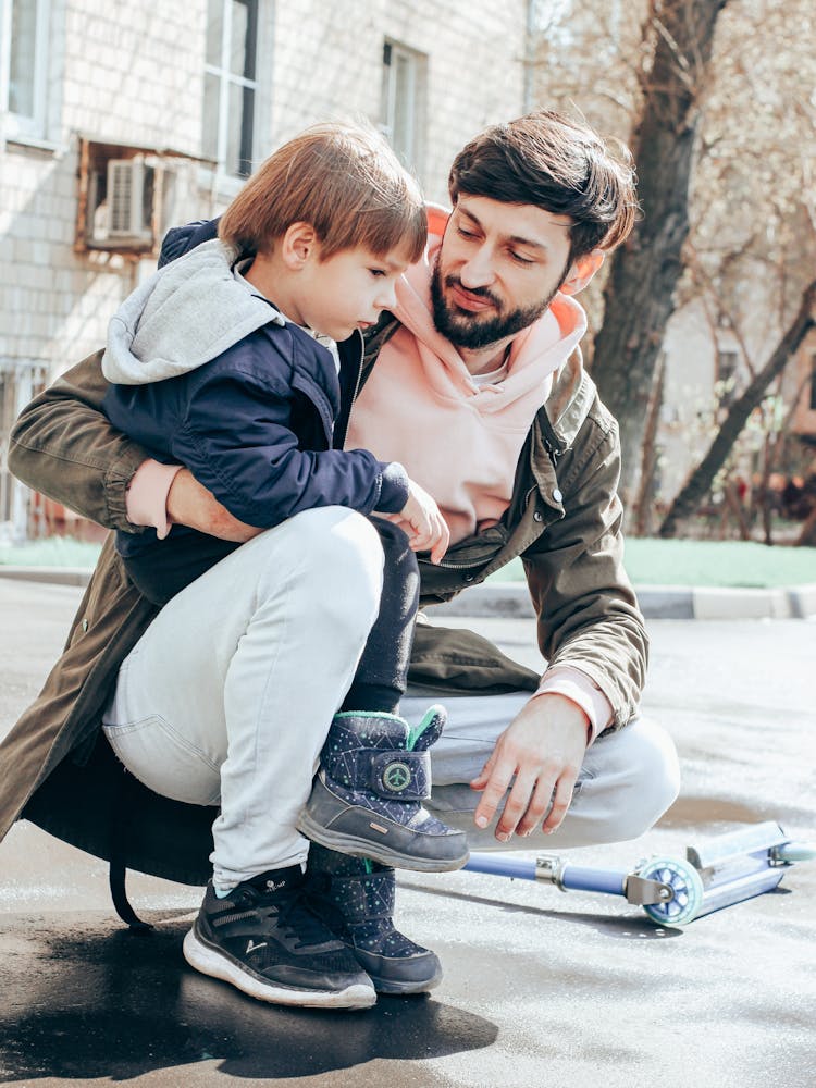 Father And Son Playing Together On Street