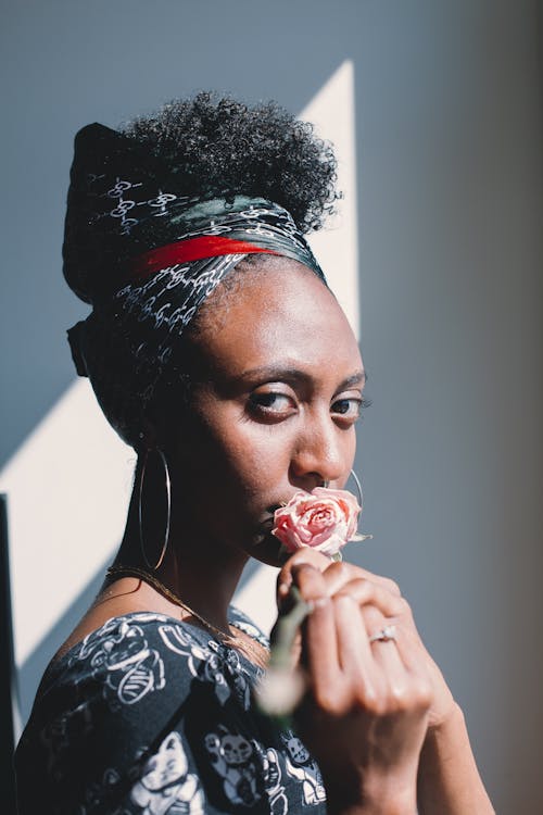 Woman Holding a Flower to her Lips