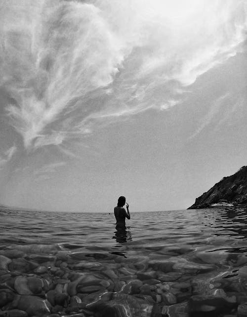 Anonymous woman recreating in sea during summer holidays