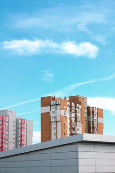 Colorful highrise apartment buildings under a clear blue sky on a sunny day.