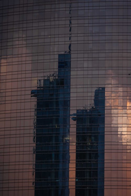 Free Reflection of towers in glass skyscraper Stock Photo