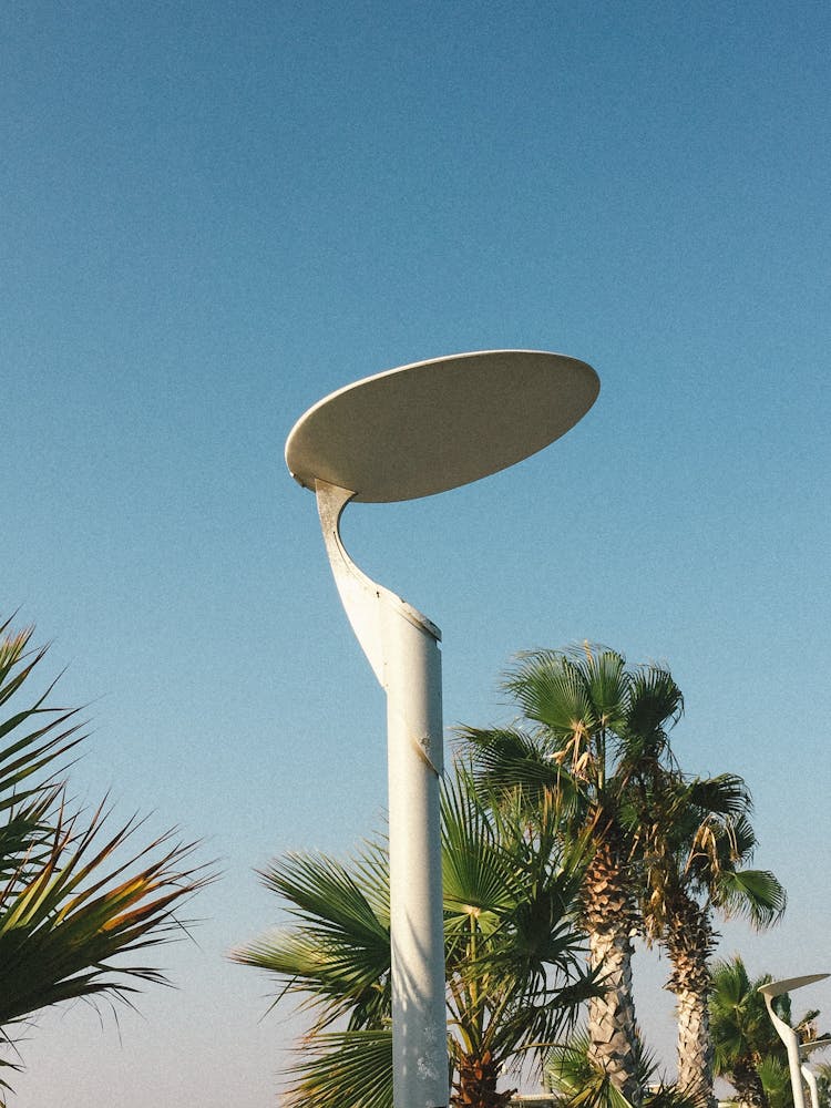 Modern Light Pole On Street Against Blue Sky