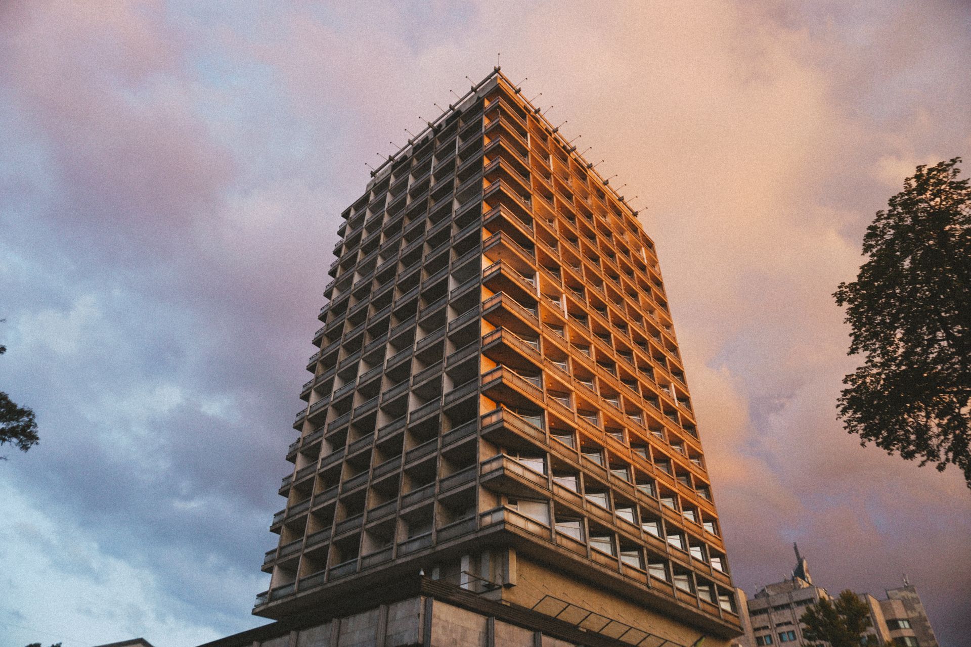 A towering highrise building in Kyiv under a beautiful dusk sky, highlighting urban architecture.