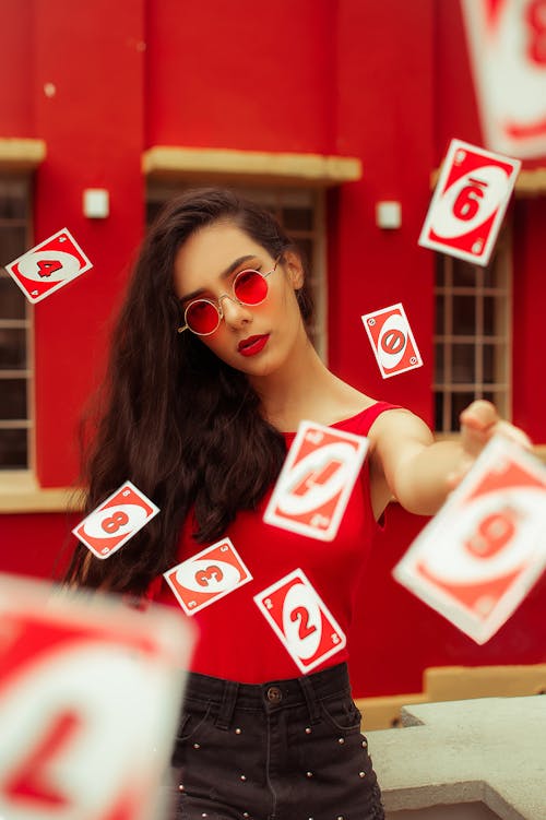 Free Beautiful woman throwing playing cards in air Stock Photo