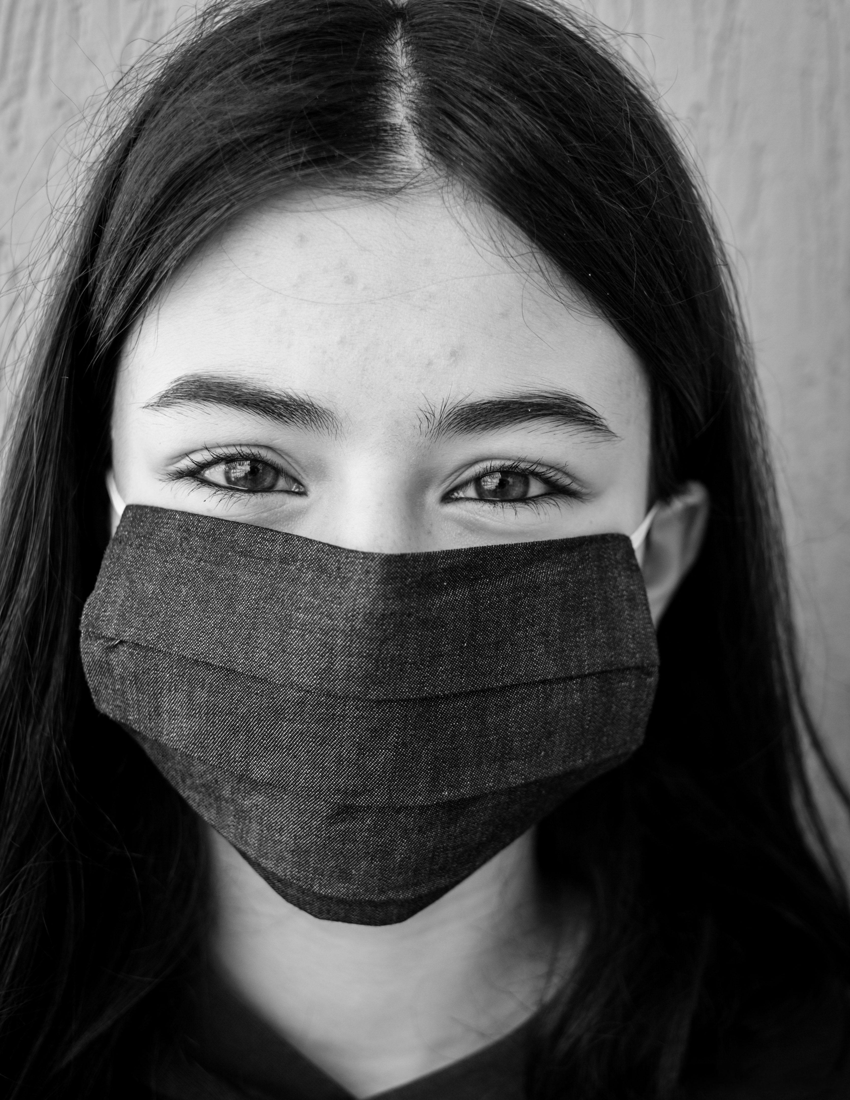 Positive young woman in face mask · Free Stock Photo