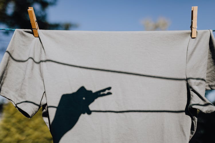 Silhouette Of Hand With Clothespin Making Crocodile