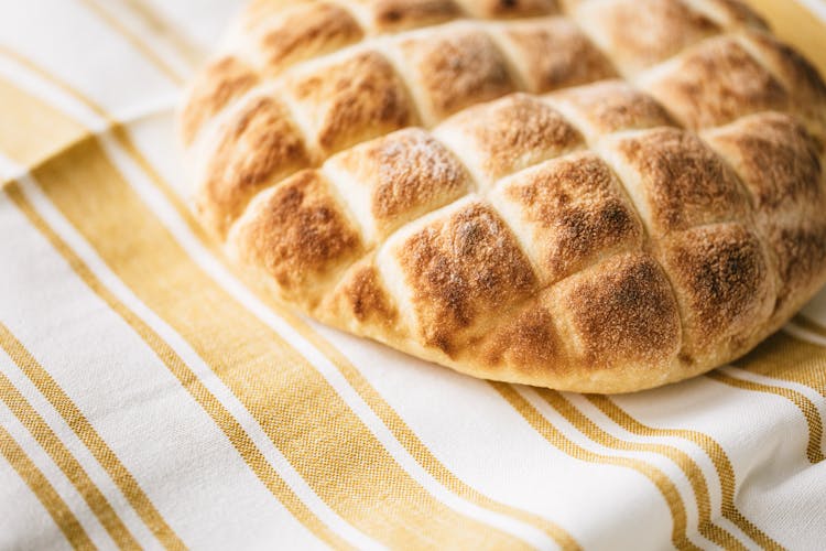 Fresh Baked Bread On Striped Tablecloth