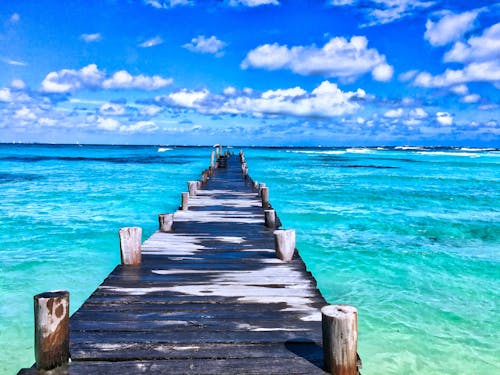 Brown Wooden Dock Across Clear Ocean