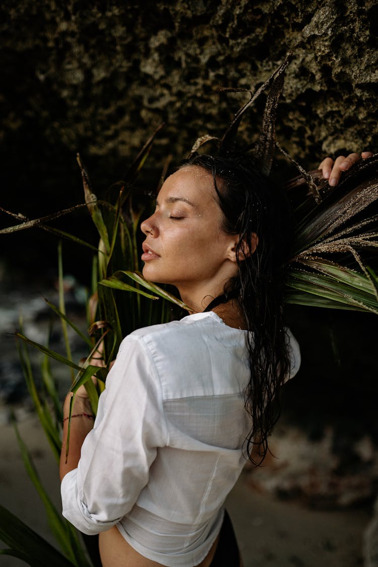 Young Lady Hugging Palm Branch On Seashore