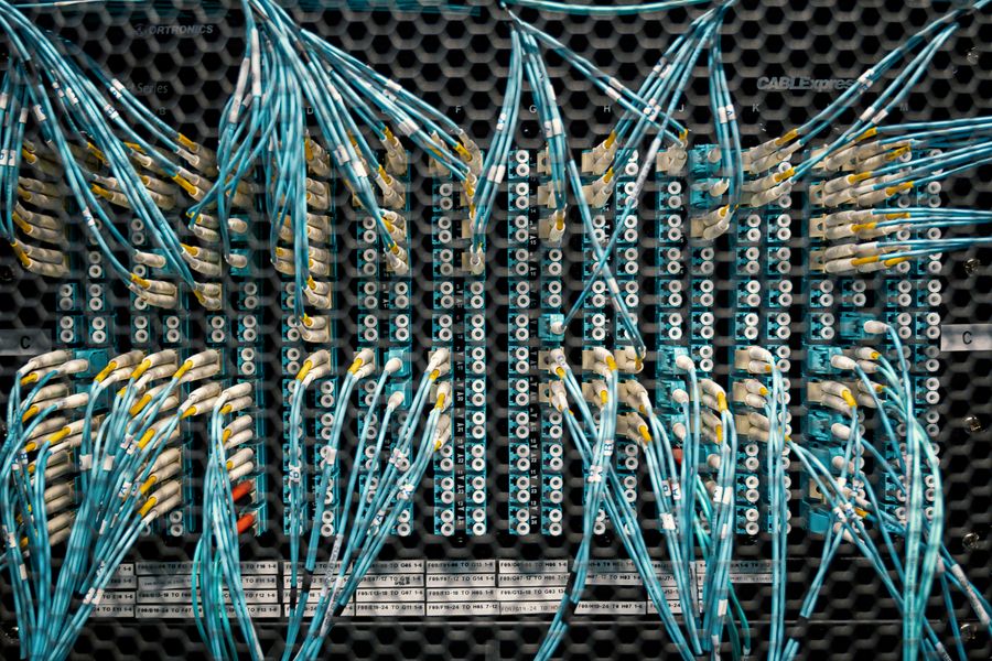 Overhead view of fiber optic switch with bright cables and connectors