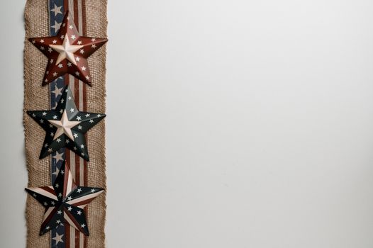 Overhead view of ribbon with stripes and stars representing liberty and democracy of USA on white background