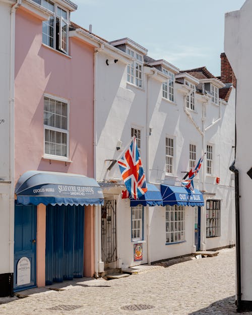 Free British Flags Displayed Over Building Entrance  Stock Photo