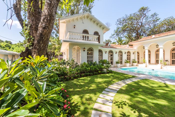 Single story villa with a pool and landscaped garden, reference for Boca Lago villas