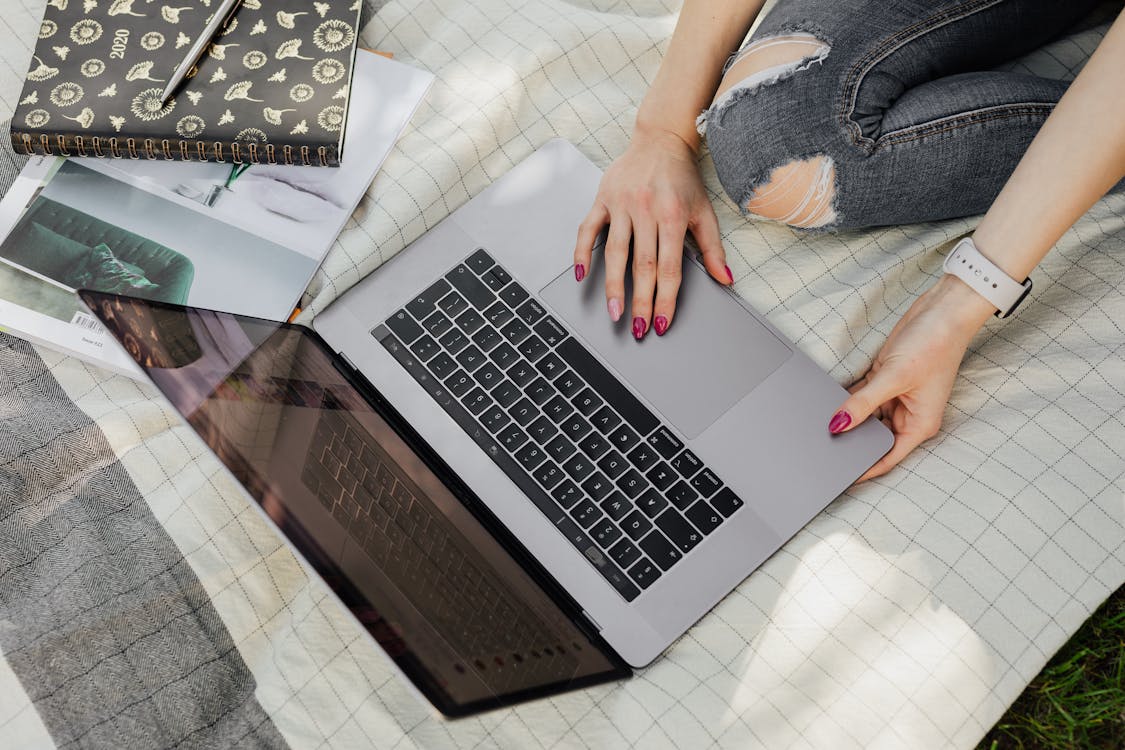 Free Crop college student using laptop in park Stock Photo
