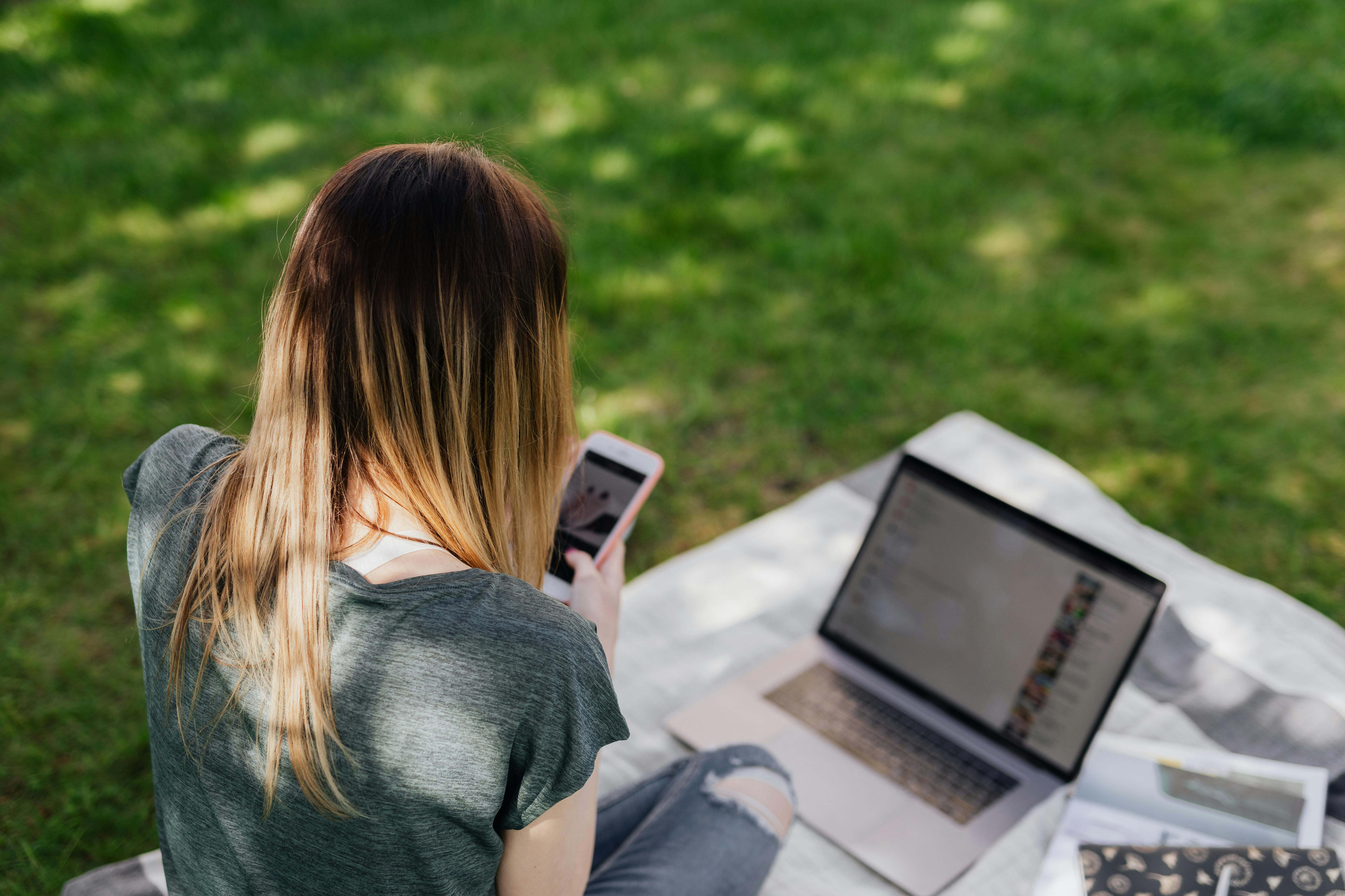 teenager surfing social media on mobile in park