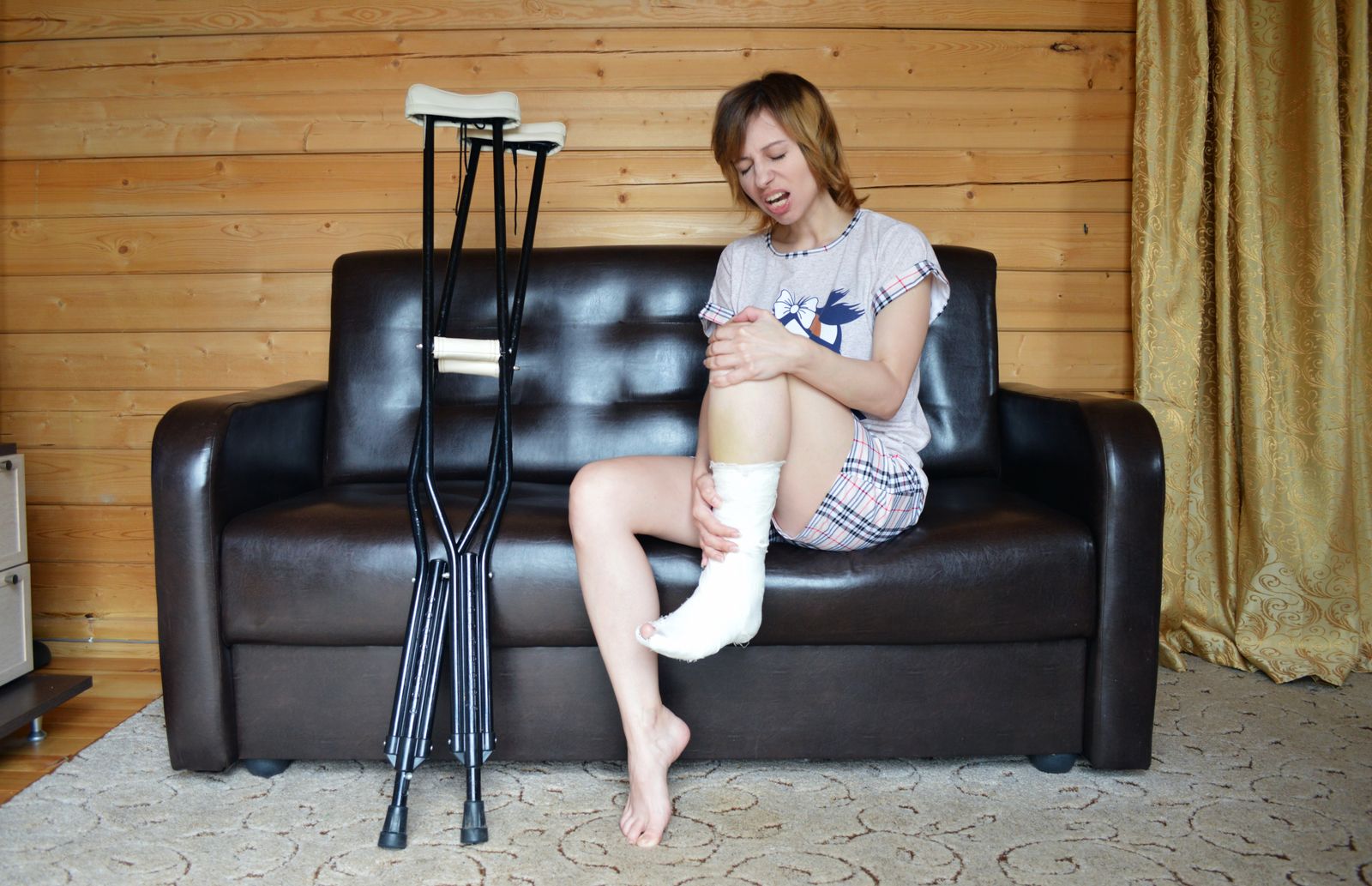 Person checking a supported ankle after outdoor activity