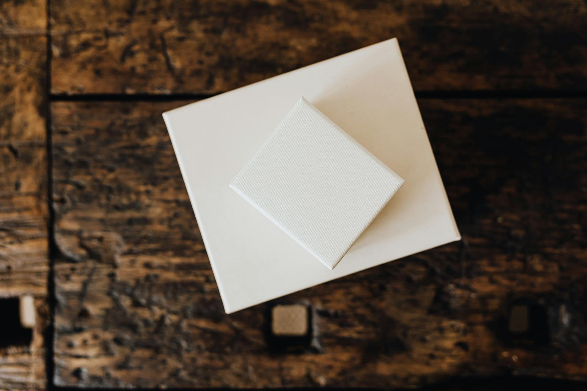 Stack of white carton boxes on wooden table