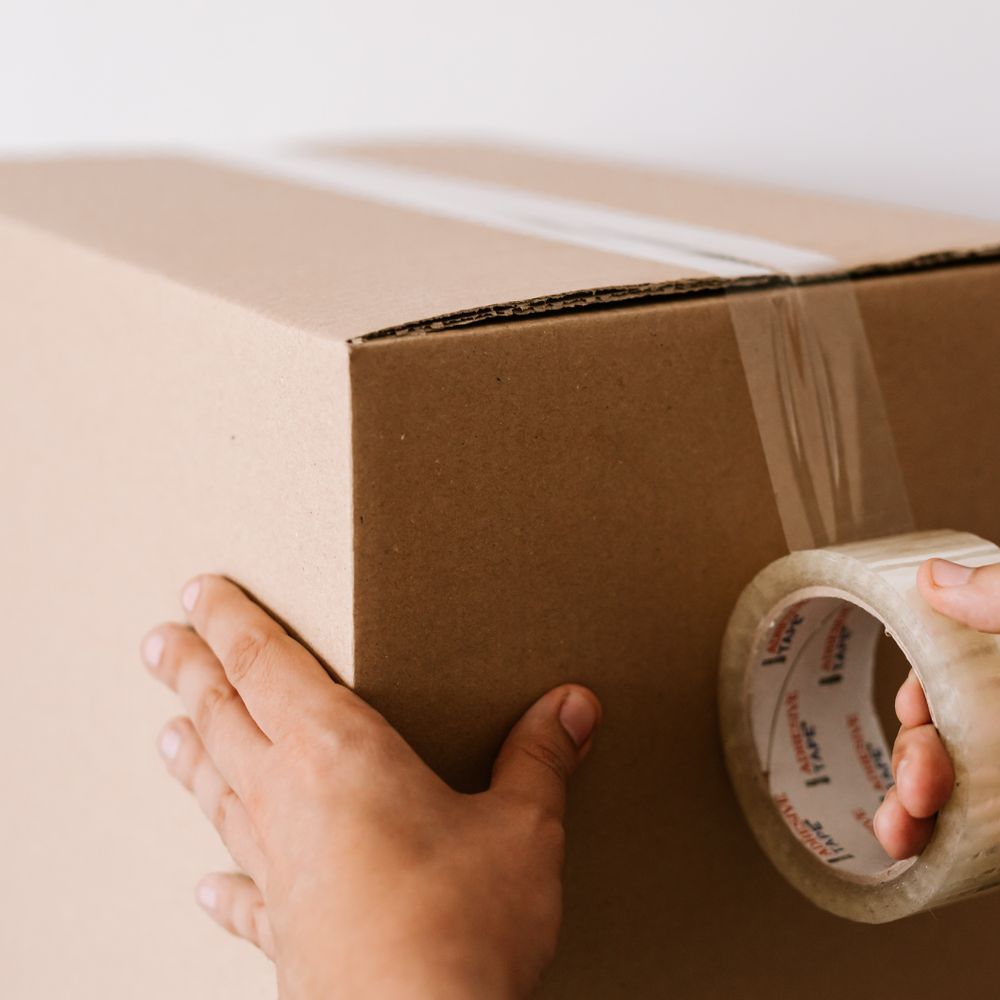Sharpness — professional packers wrapping and boxing belongings