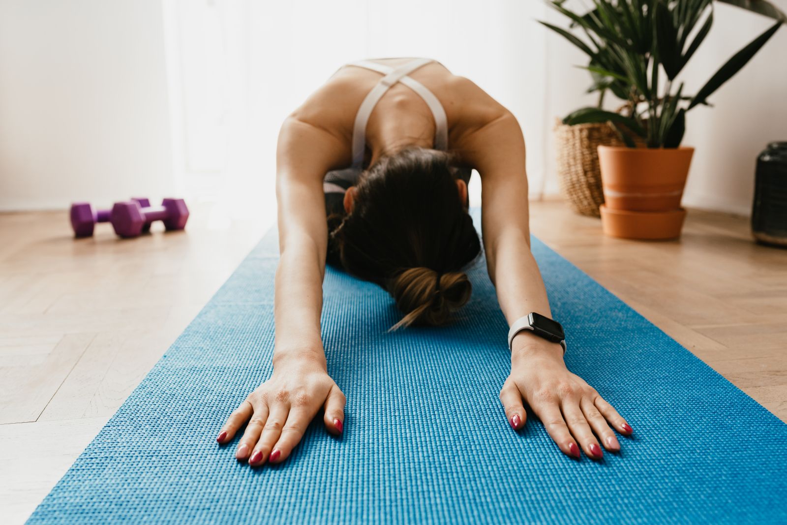 Woman resting in a supported child's pose during a restorative yoga session